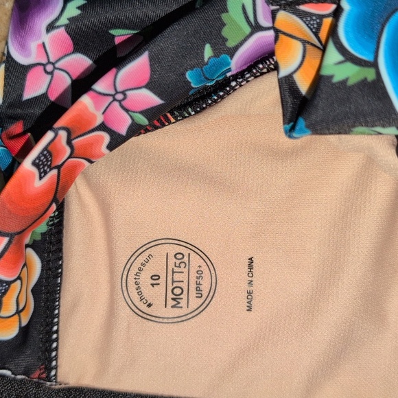 Mott50 girl one piece rash guard. Black and pink floral. Size 10. - Picture 2 of 3